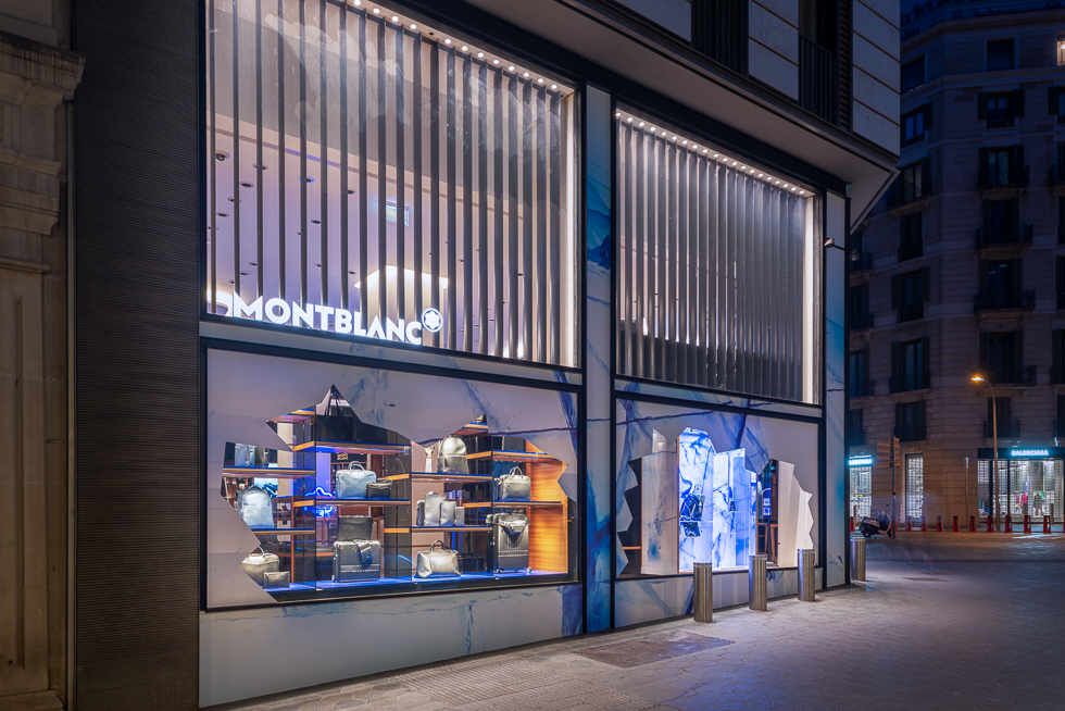 Montblanc store exterior with glacier-themed window displays featuring bags and accessories.